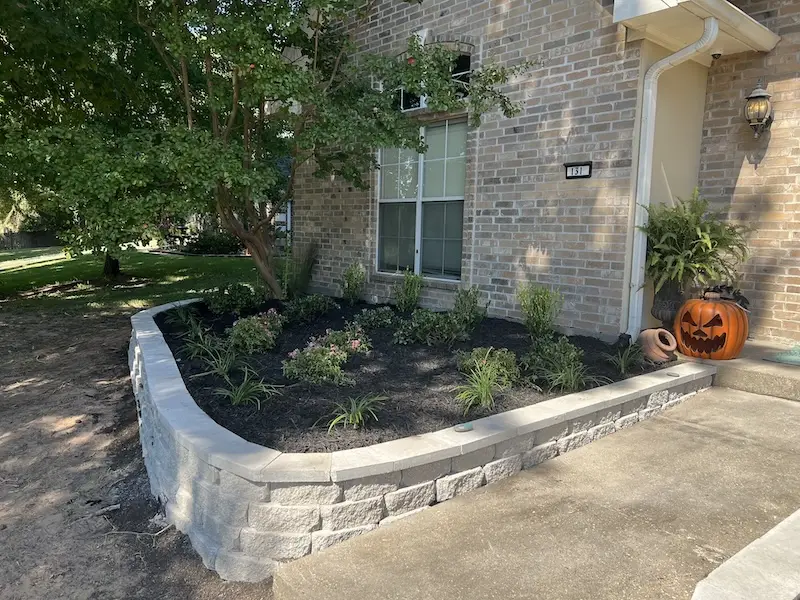 raised garden bed at shreveport home with new mulch and planted shrubs