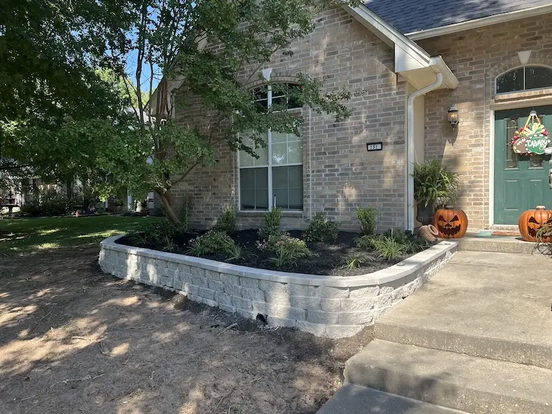 raised garden bed at shreveport home with new mulch and planted shrubs