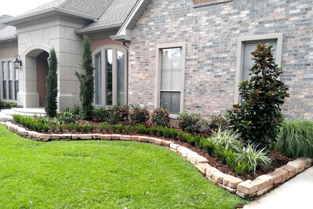 raised garden bed at shreveport home with new mulch and planted shrubs