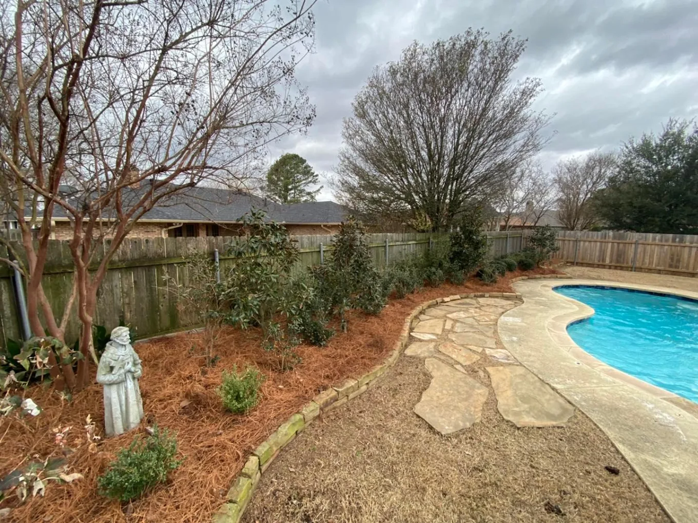 raised garden bed at shreveport home with new mulch and planted shrubs